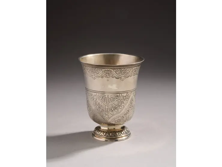 Timbale en argent de forme tulipe reposant sur un pied ciselé d’oves et de miroirs.